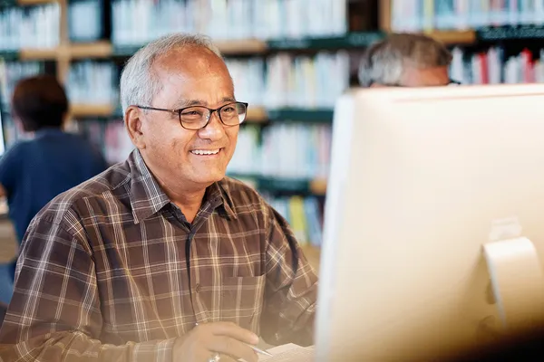 man at library in front of screen