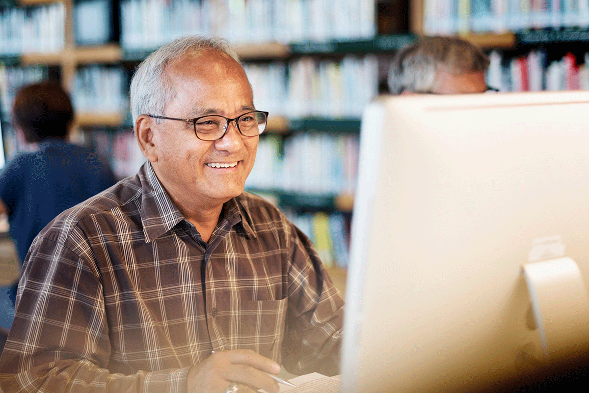 man at library in front of screen