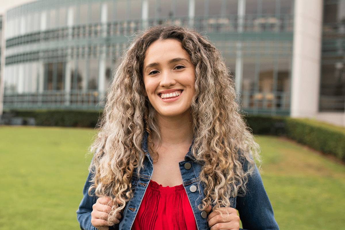woman outside in front of architectural building