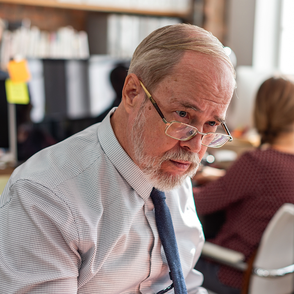 Portrait of a man in glasses at a restaurant.