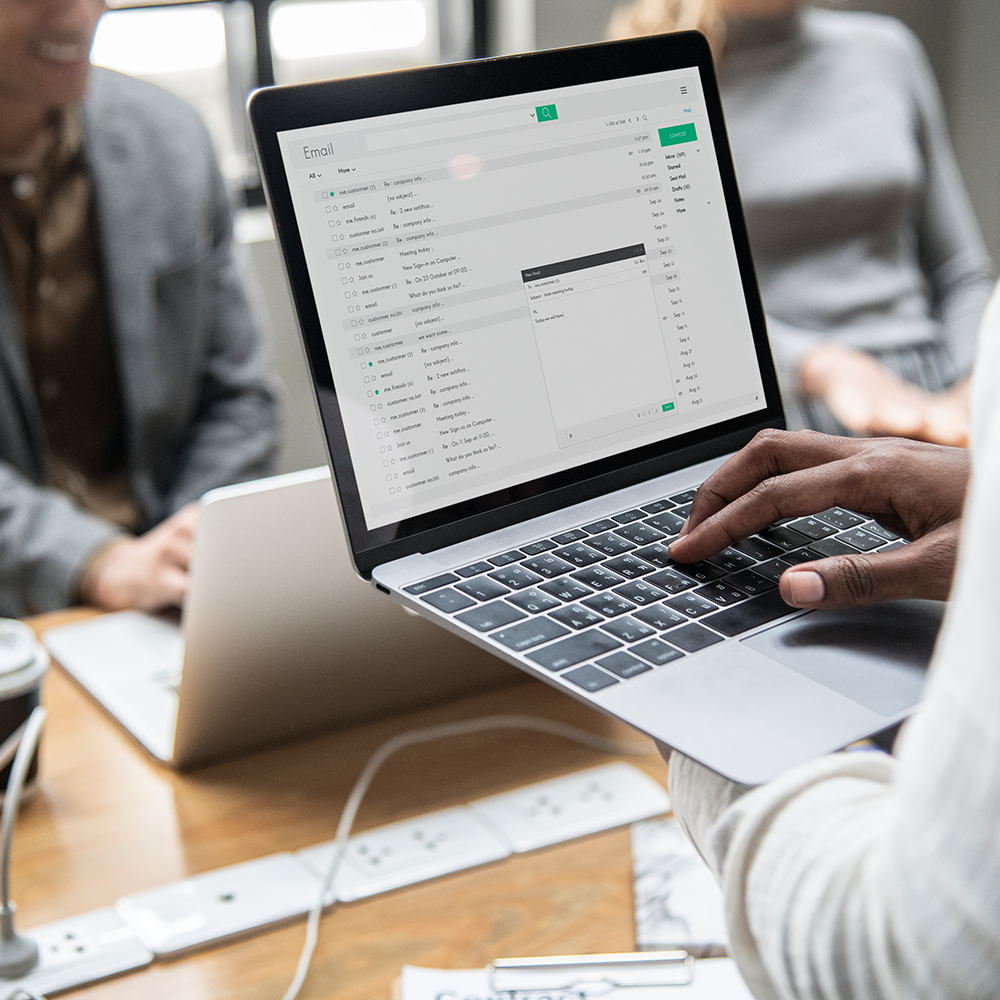 A macbook held up over a table.