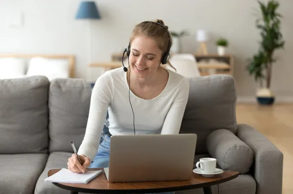 woman on couch with laptop